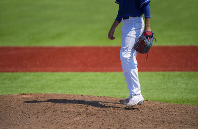 Low section of baseball player standing on playing field