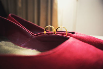 Close-up of wedding rings and shoes at home