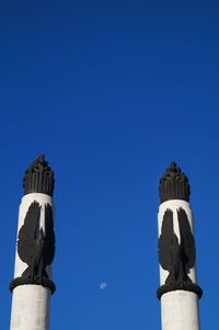 Low angle view of historic statue against clear blue sky