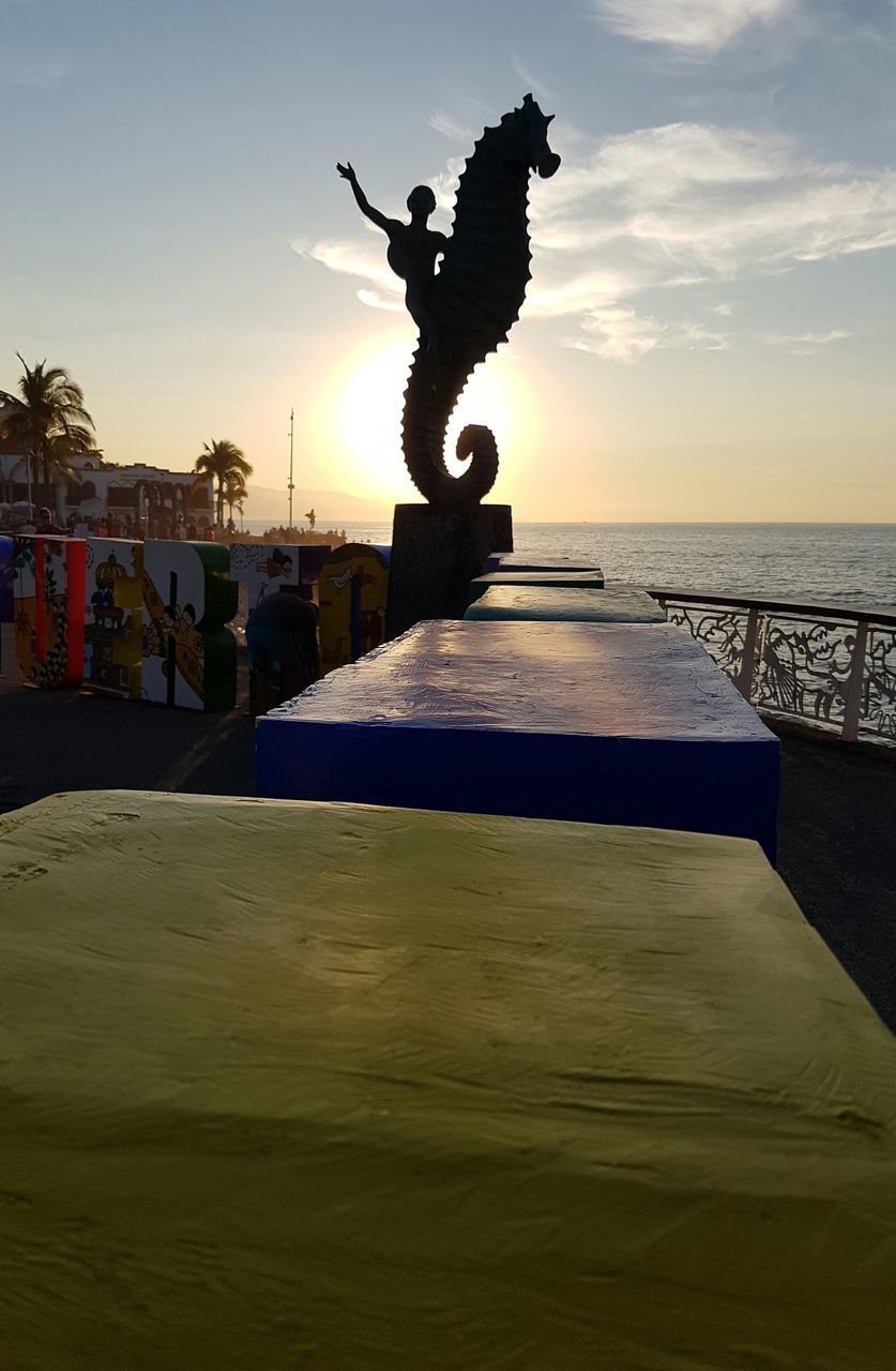 STATUE AT BEACH AGAINST SKY