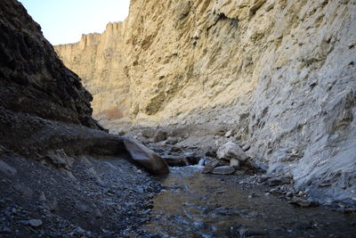 Stream flowing amidst rocky mountains