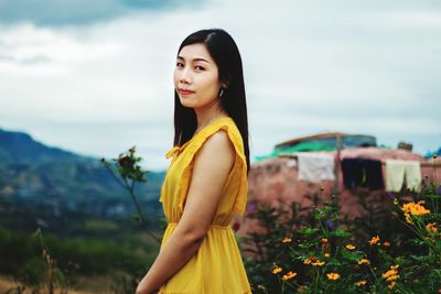 Side view of a beautiful young woman standing on land