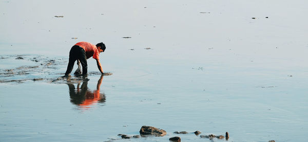 Reflection of man in sea