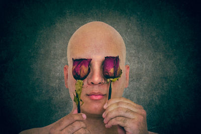 Close-up portrait of man wearing mask against gray background