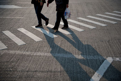 Low section of people walking on road