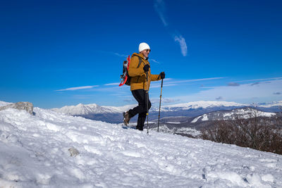Low angle view of man skiing on snow