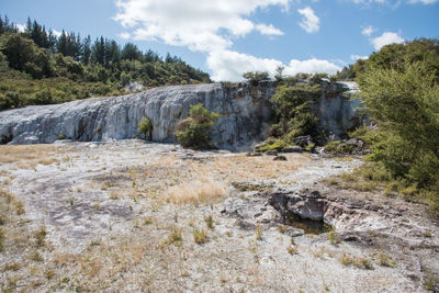 Scenic view of waterfall against sky