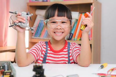 Portrait of girl playing with toy blocks at home