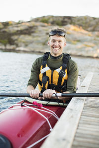 Portrait of happy man kayaking in river