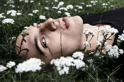 Young man lying down on grass