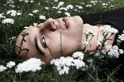 Young woman lying down on grass