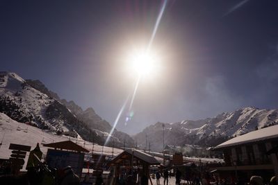 Sun shining over snowcapped mountains