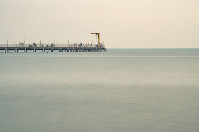 Pier over sea against clear sky