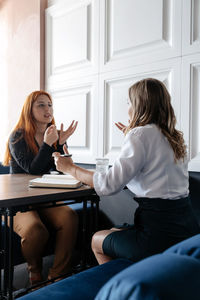 Side view of women talking with psychotherapist