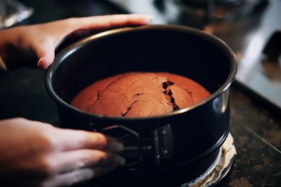 Cropped hand making cake