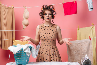 Full length of woman standing against wall