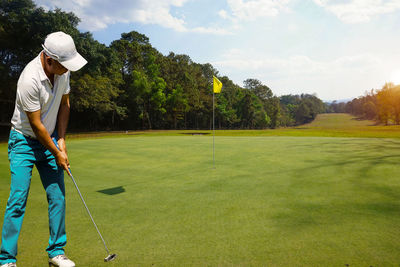 Background of evening golf course has sunlight shining down at golf course in thailand. 