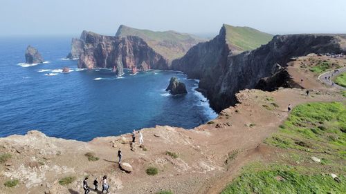 Scenic view of sea and mountains against sky