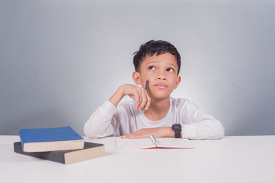 Portrait of boy on table