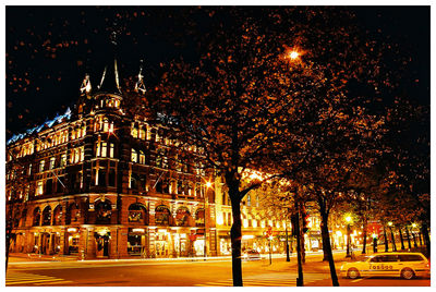 Illuminated building against sky at night