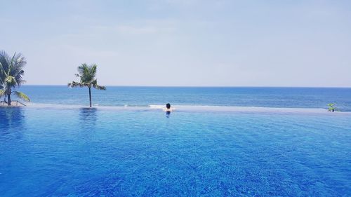 Scenic view of swimming pool by sea against sky