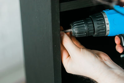 Cropped hand of man repairing car