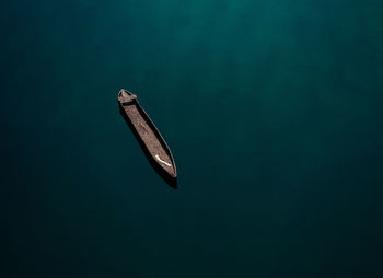 Aerial view of an isolated canoe drifting peacefully on the nyong river at ebogo
