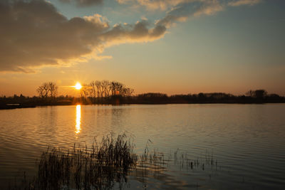 Scenic view of lake against sky during sunset