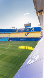 Information sign on field against sky