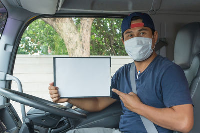 Portrait of man sitting in car