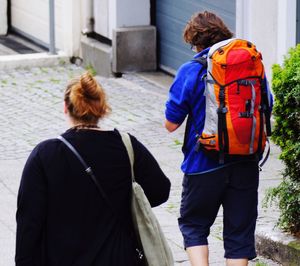 Rear view of women walking on zebra crossing