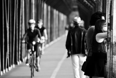 Rear view of people walking on footpath