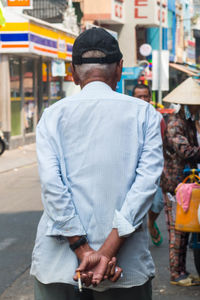 Rear view of man standing on street