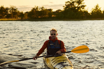Man kayaking on sunny autumn day