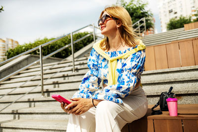 Portrait of young woman using mobile phone