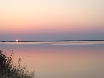 Scenic view of calm sea at sunset