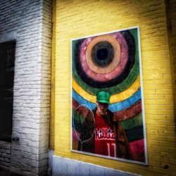 Close-up of multi colored light on yellow wall