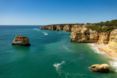 Scenic view of sea against clear blue sky