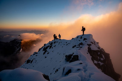 Scenic view of snowcapped mountains against sky during sunset