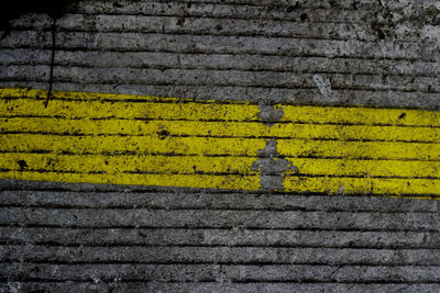 High angle view of yellow sign on wall