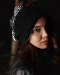 Close-up portrait of beautiful woman wearing knit hat