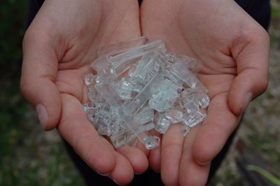 Close-up of hand holding plastic objects