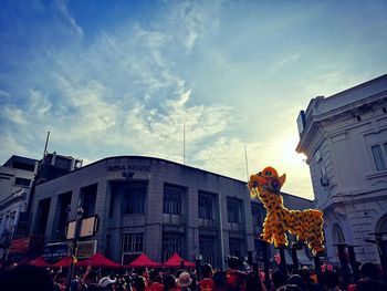 People on street against buildings in city