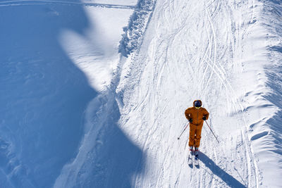 High angle view of person skiing on snow covered field