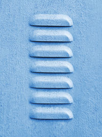 Close-up blue grainy painted sheet metal louvers pattern