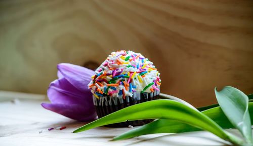 Close-up of cupcake and flower on table