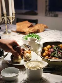 Midsection of person having food on table