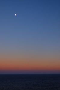Scenic view of sea against clear sky at sunset