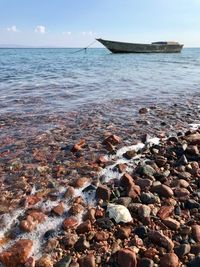 Rocks on beach against sky