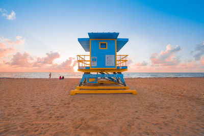 Lifeguard hut on beach against sky